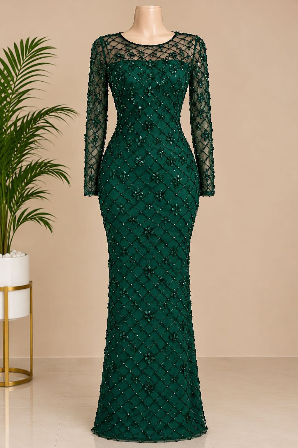 long-sleeved, fitted evening gown in deep green, covered in beadwork and sequins for dressy occasions.